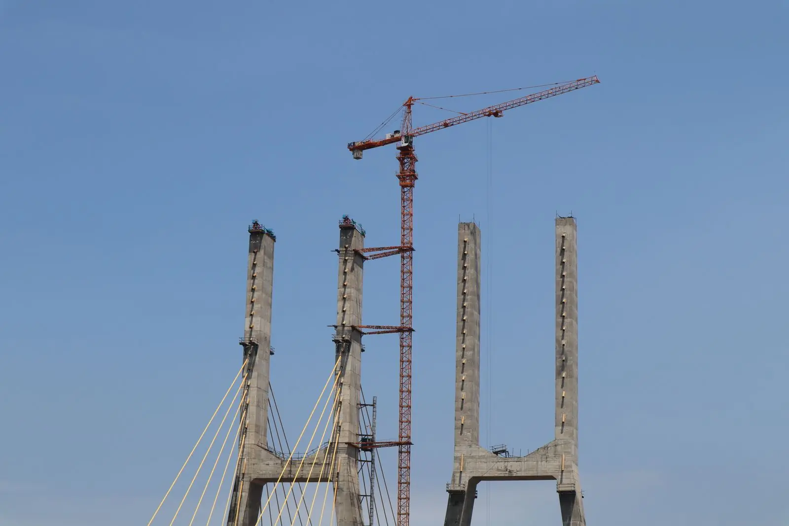 Cable-stayed bridge under construction with a crane