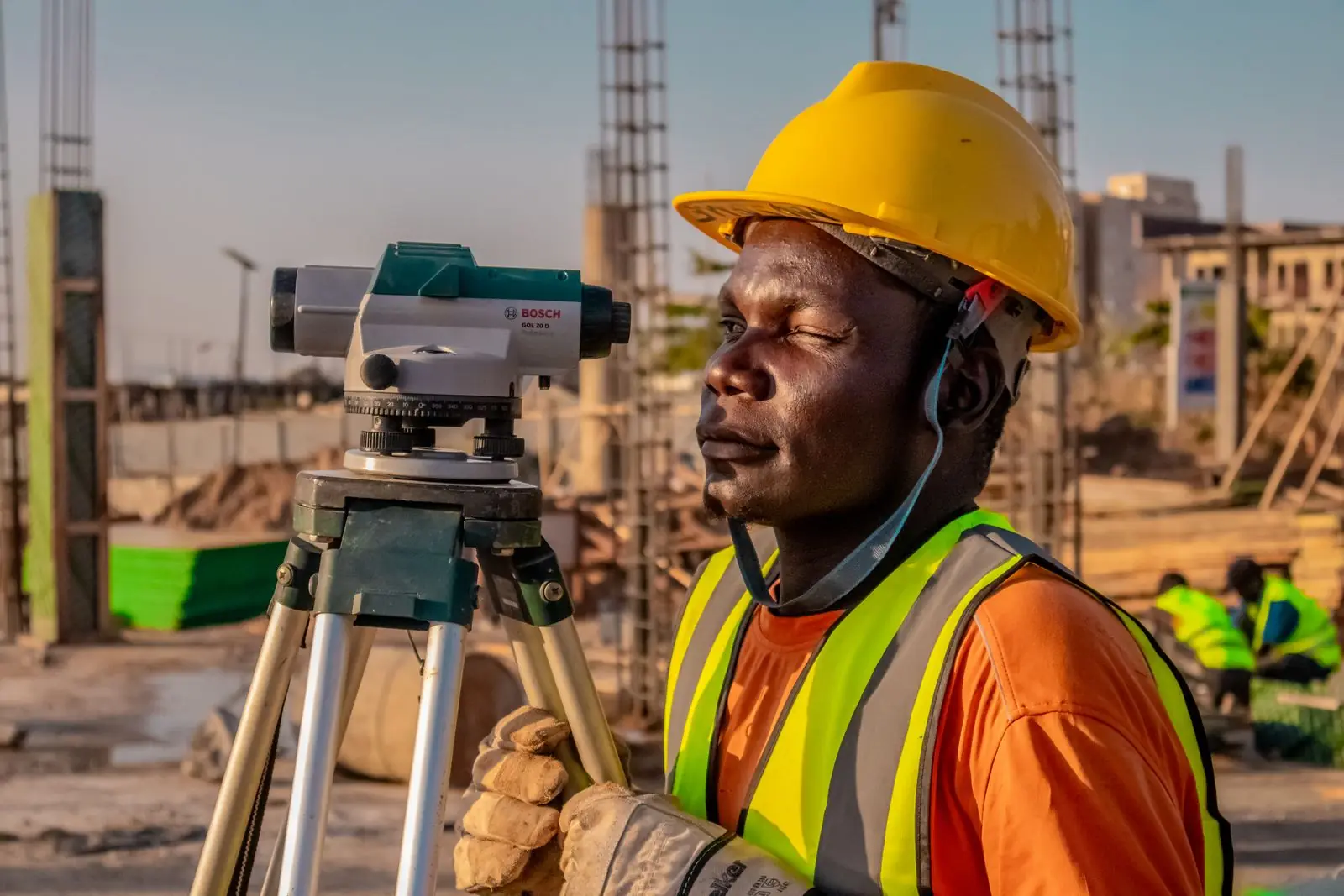 Engineer using survey equipment on a construction site