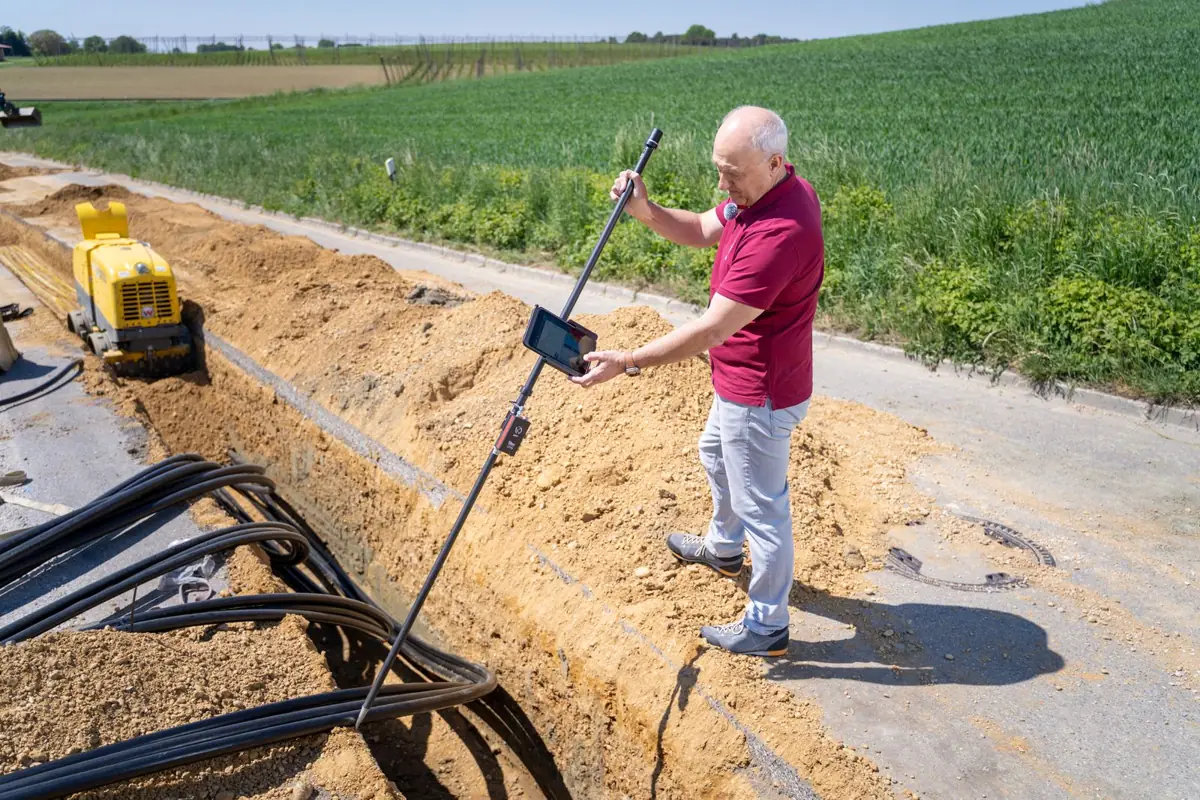 Engineer surveying a construction site with equipment