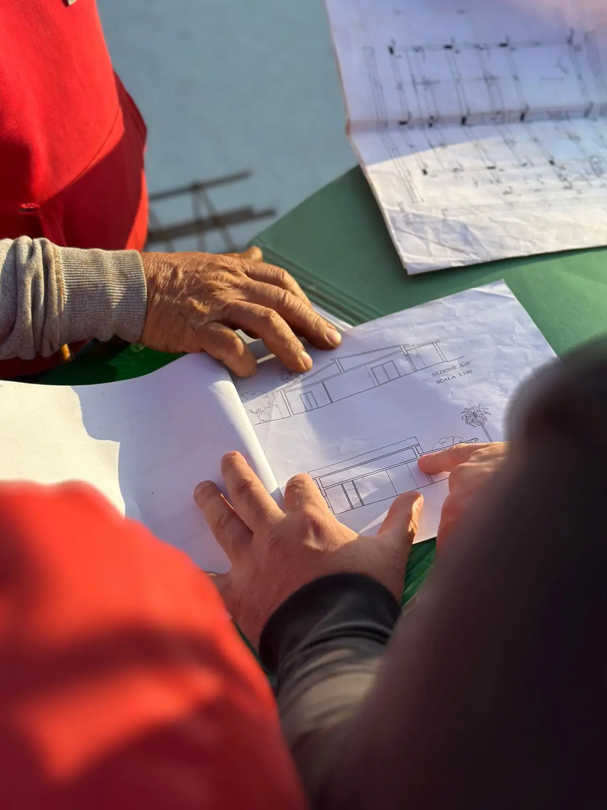 Engineers reviewing construction plans outdoors